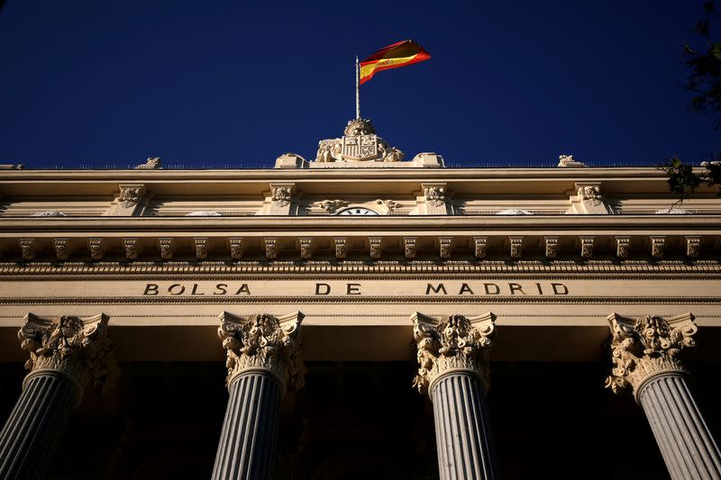 FILE PHOTO: A Spanish flag flutters above the Madrid Stock Exchange