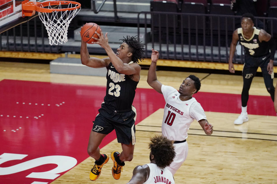 Purdue guard Jaden Ivey (23) goes up for a layup next to Rutgers guard Montez Mathis (10) during the second half of an NCAA college basketball game Tuesday, Dec. 29, 2020, in Piscataway, N.J. (AP Photo/Kathy Willens)