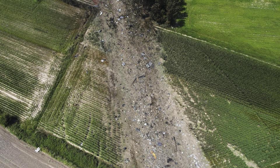 This drone photo shows the site where the AN-12 cargo plane crashed, in Palaiochori village near the town of Kavala, in northern Greece, Sunday, July 17, 2022. Experts are poised to investigate the site of a plane crash in northern Greece to determine whether any dangerous chemicals or explosive cargo remains. (AP Photo/Giannis Papanikos)