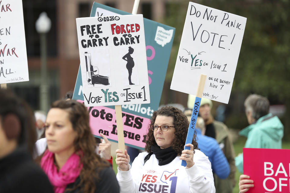 FILE - A supporter of Issue 1, the Right to Reproductive Freedom amendment, attends a rally held by Ohioans United for Reproductive Rights at the Ohio Statehouse in Columbus, Ohio, on Oct. 8, 2023. As campaigning escalates in Ohio's fall fight over abortion rights, a new line of attack from opponents suggests "partial-birth" abortions would be revived if a proposed constitutional amendment passes. (AP Photo/Joe Maiorana, File)