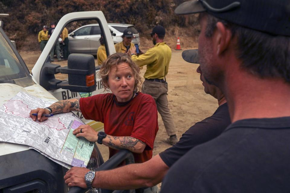 Bureau of Land Management firefighters plan an attack on the Bobcat fire.