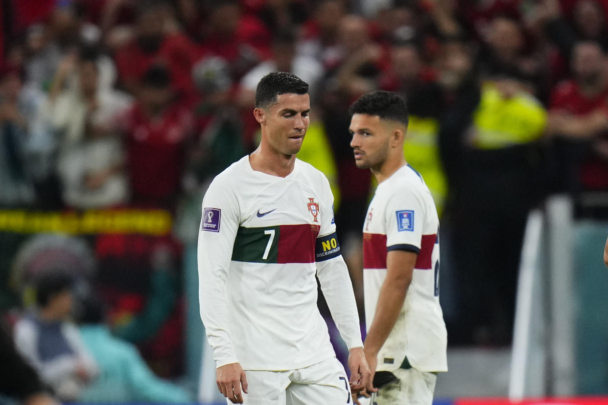 Portugal's Cristiano Ronaldo, left, and Portugal's Goncalo Ramos react end of the World Cup quarterfinal soccer match between Morocco and Portugal, at Al Thumama Stadium in Doha, Qatar, Saturday, Dec. 10, 2022. (AP Photo/Petr David Josek)