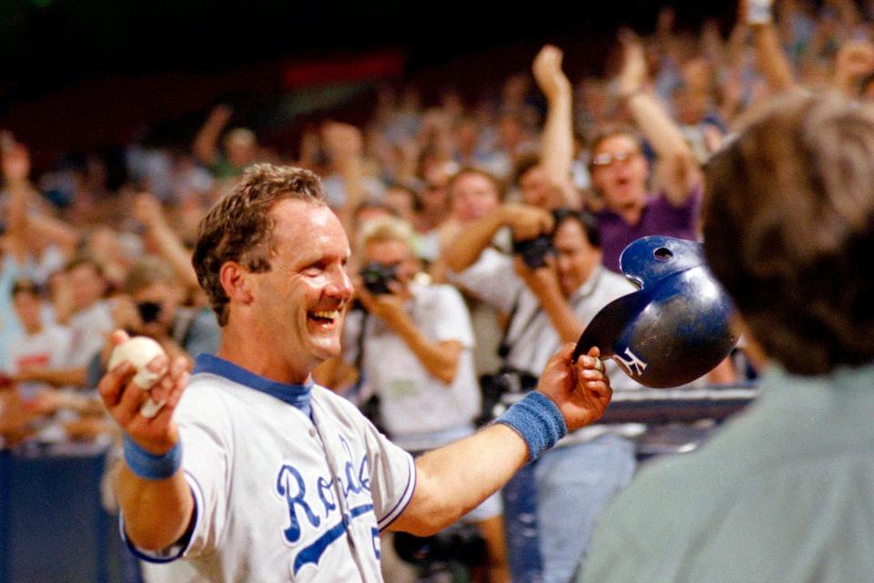 FILE - In this Sept. 30, 1992, file photo, Kansas City Royals' George Brett holds the ball he hit as he heads toward the Royals' dugout after hitting his 3,000th career hit, against the California Angels in Anaheim, Calif. Baseball's amateur draft this week will look much different because of the coronavirus pandemic, and more permanent changes could be coming soon.