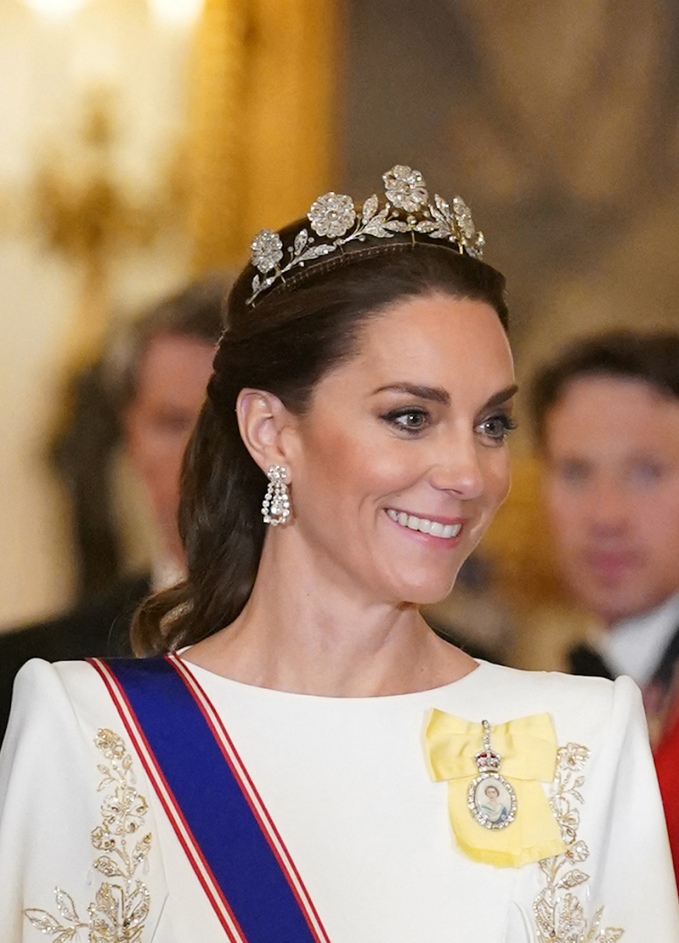 <p> At the state banquet thrown in South Korea's honour in 2023, Kate stood out in a white Jenny Packham cape-style gown with gold detailing. She elevated her look with long white gloves and a satin-effect clutch bag - but it was her beautiful tiara which stood out. </p>