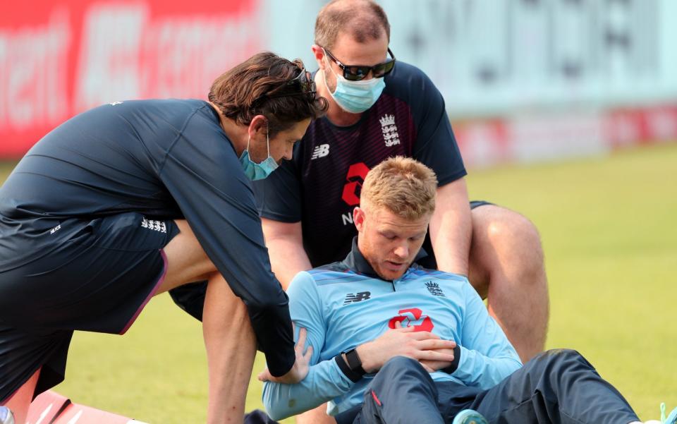 Sam Billings of England has treatment on his shoulder after picking up an injury - Surjeet Yadav/Getty Images