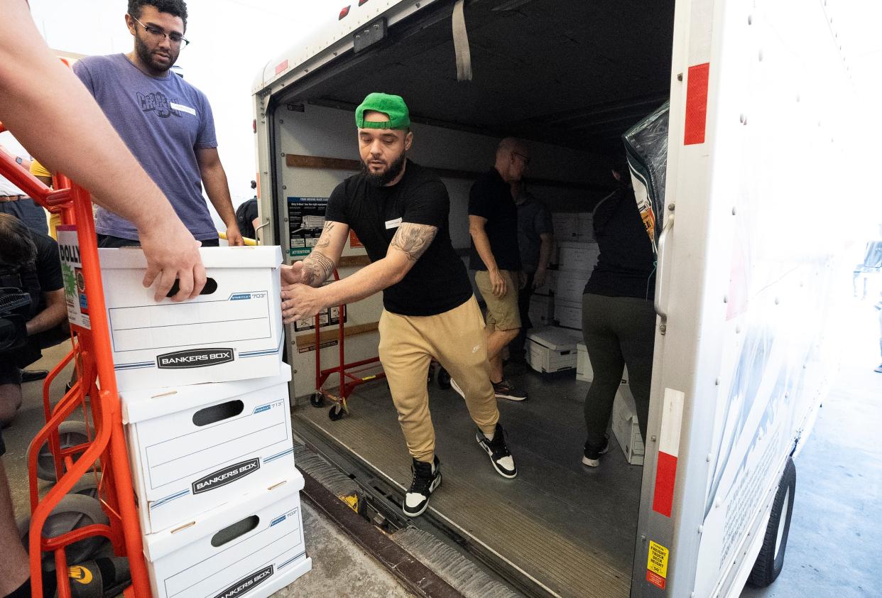 Ohioans for Reproductive Freedom Field Worker Carlos Ortez helps to unload boxes of signatures for the reproductive freedom ballot initiative at the loading dock of the office of the Secretary of State's office in Downtown Columbus.