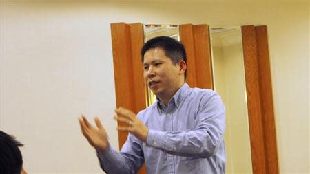 Chinese rights advocate Xu Zhiyong speaks during a meeting in Beijing in this handout photo dated March 30, 2013. REUTERS/Xiao Guozhen/Handout