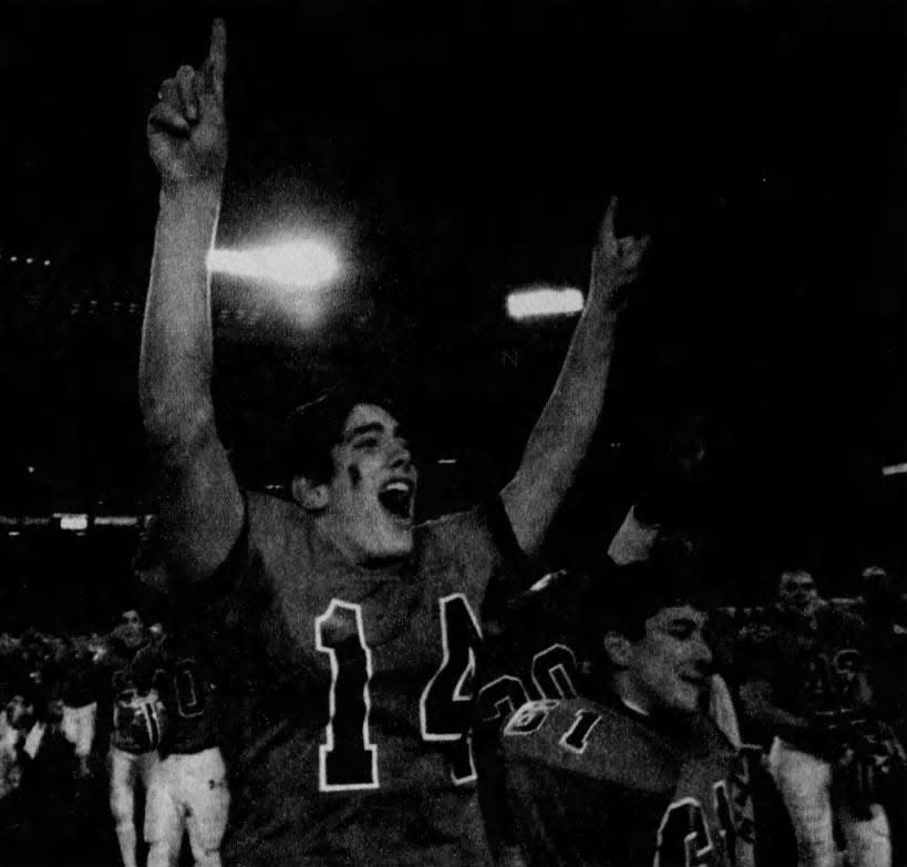 Hunterdon Central quarterback Andrew Conforti raises his arms in celebration Saturday, Dec. 5, 1998, after leading the Red Devils to a crushing 42-6 victory over Piscataway in the Central Jersey Group IV championship game at Giants Stadium. The victory capped an undefeated season.