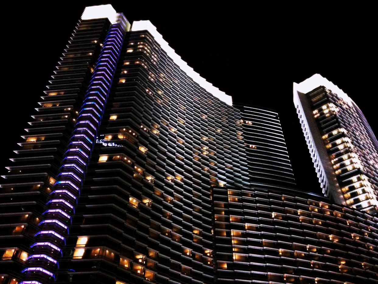 Night view of Aria Resort & Casino with black sky in background.