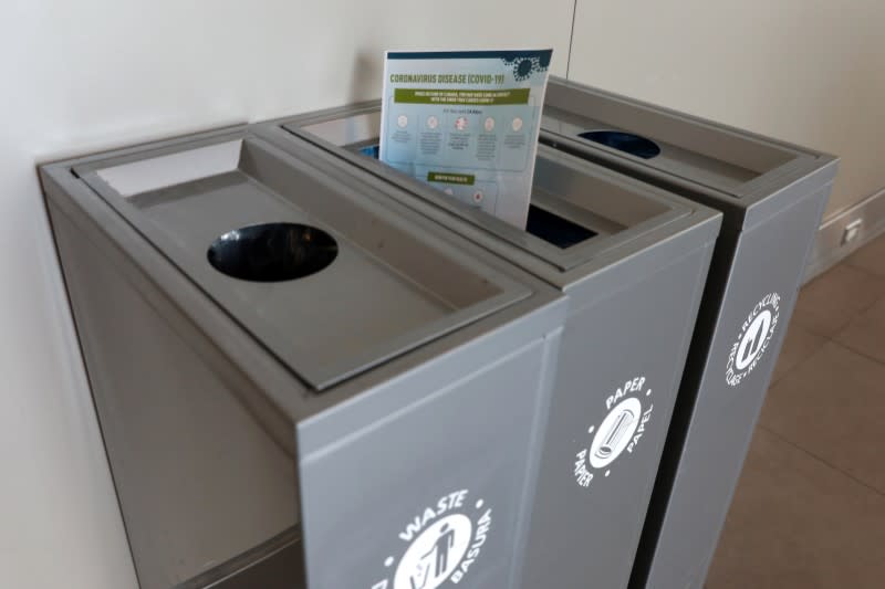 FILE PHOTO: A health pamphlet about novel coronavirus disease (COVID-19) is seen in a recycling bin at Billy Bishop Airport in Toronto