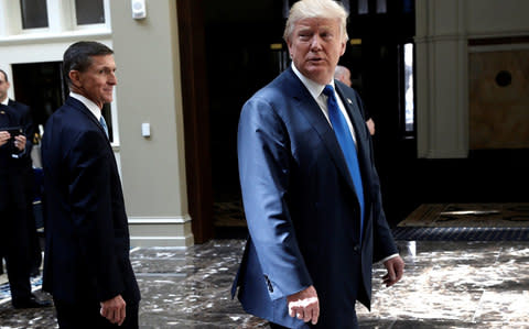 Then-Republican presidential nominee Donald Trump and retired U.S. Army Lieutenant General Michael Flynn (L) walk through the atrium of his new Trump International Hotel in Washington, D.C., U.S., September 16, 2016 - Credit: Reuters