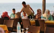 Palestinians gather for Iftar, the nightly breaking of the Ramadan fast, on the terrace of the Roots hotel in Gaza City July 2, 2015. REUTERS/Mohammed Salem