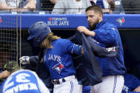 Toronto Blue Jays starting pitcher Alek Manoah (6) puts the home run jacket on teammate Bo Bichette after his solo homer in the fourth inning of a baseball game against the Cincinnati Reds in Toronto, Saturday, May 21, 2022. (Frank Gunn/The Canadian Press via AP)