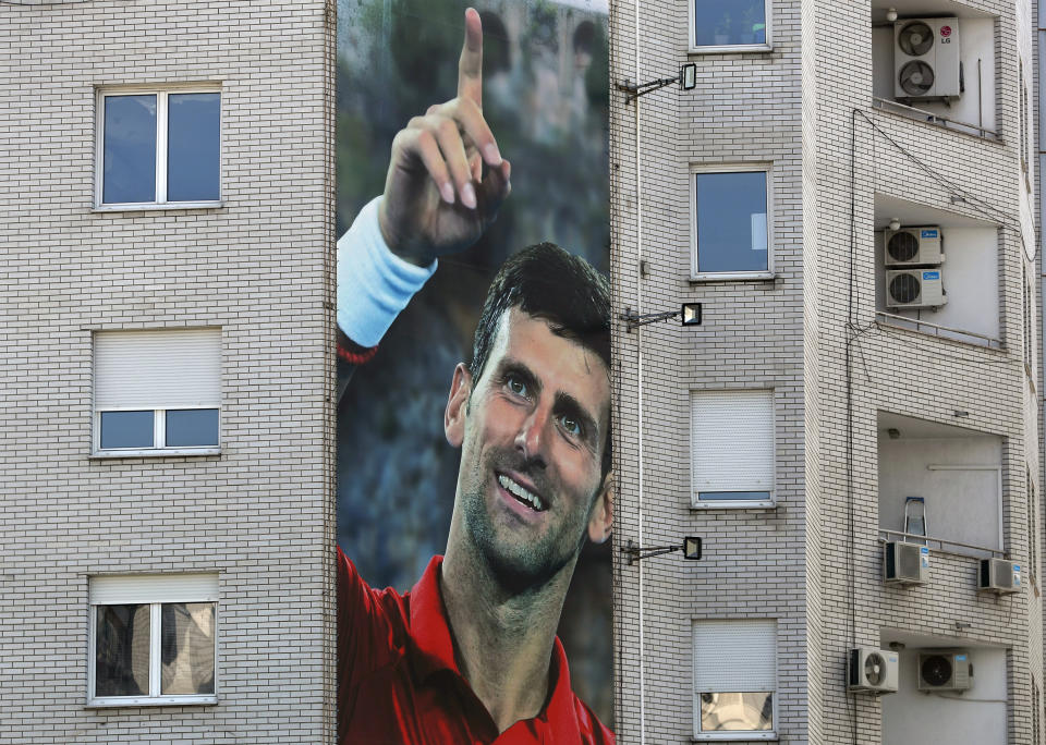 A billboard depicting Serbian tennis player Novak Djokovic is seen on a building in Belgrade, Serbia, Wednesday, June 24, 2020. Djokovic has tested positive for the coronavirus after taking part in a tennis exhibition series he organized in Serbia and Croatia. The top-ranked Serb is the fourth player to test positive for the virus after first playing in Belgrade and then again last weekend in Zadar, Croatia.(AP Photo/Darko Vojinovic)