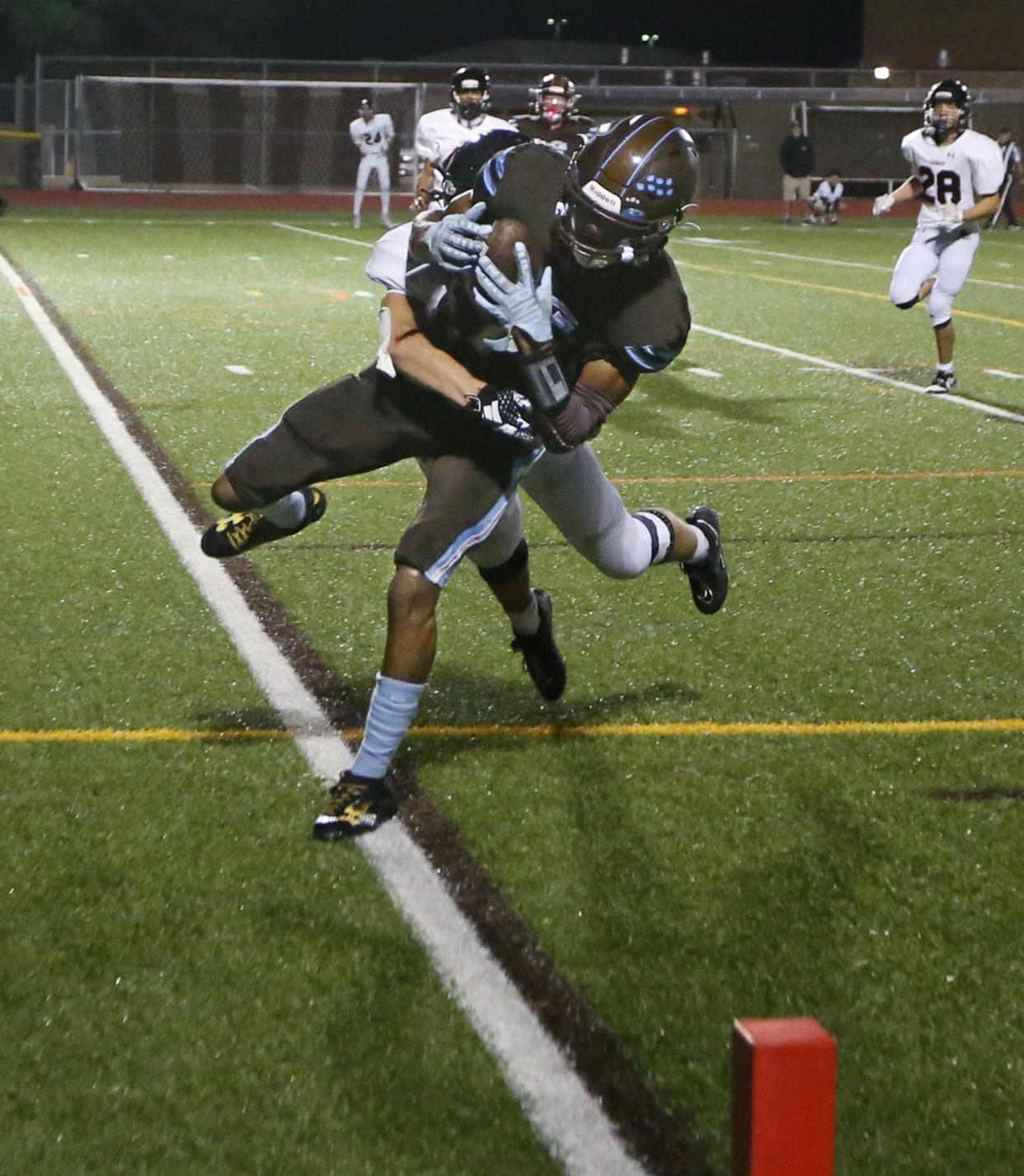 ER/Gananda wide receiver Miles Caviness pulls in the touchdown reception and drags LeRoy's Andrew Strollo into the end zone on the play.