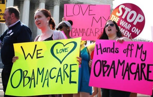 Obamacare supporters demonstrate in front of the U.S. Supreme Court on June 28. With Chief Justice John Roberts' decisive swing vote to uphold "Obamacare," the conservative-majority US Supreme Court has seen its reputation as an independent final arbiter restored, experts say