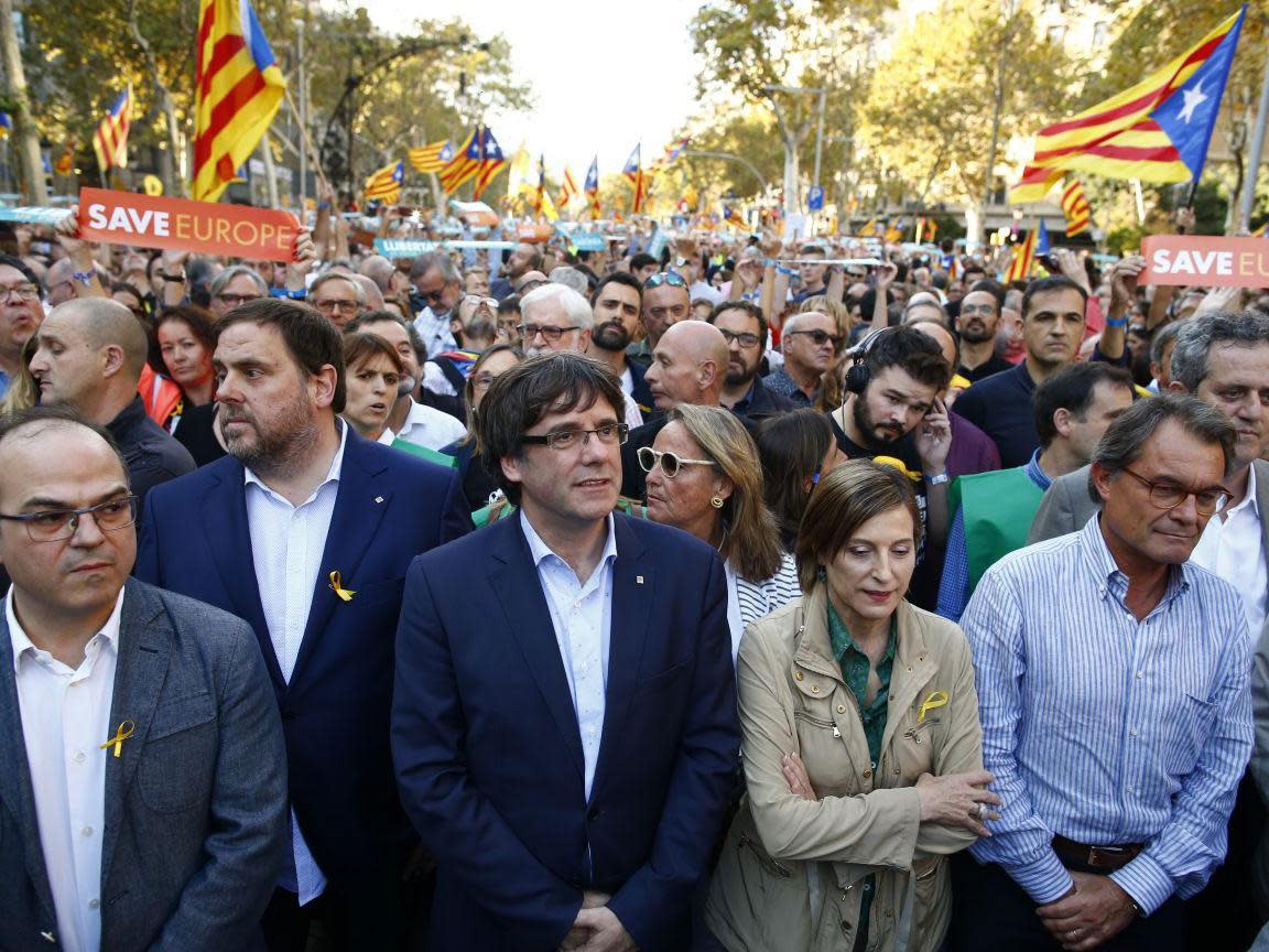 Carles Puigdemont joined thousands at a march to protest against Mariano Rajoy's speech: AP