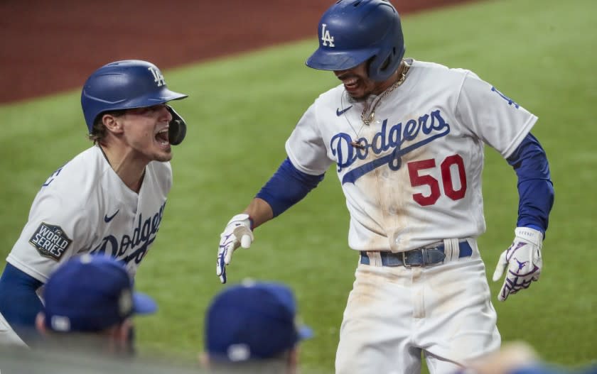 Arlington, Texas, Tuesday, October 27, 2020 Mookie Betts is congratulated by teammate Kike Hernandez after homering in game six of the World Series at Globe Life Field. (Robert Gauthier/ Los Angeles Times)