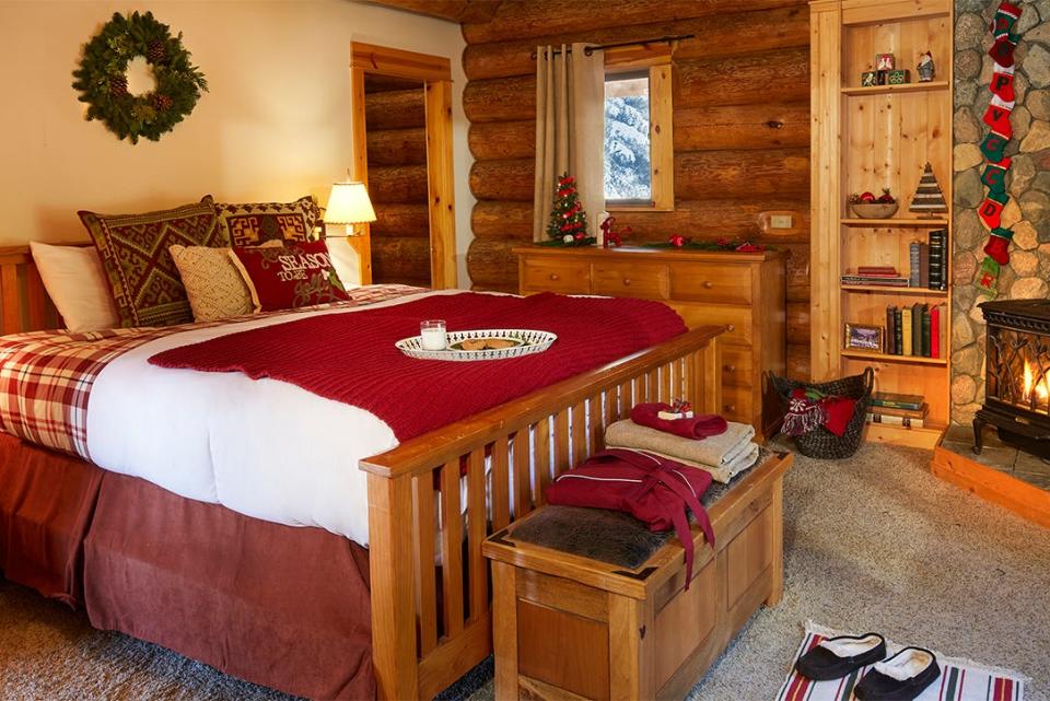 Photo of Santa's bedroom with a wooden bed with red and cream cushions on top