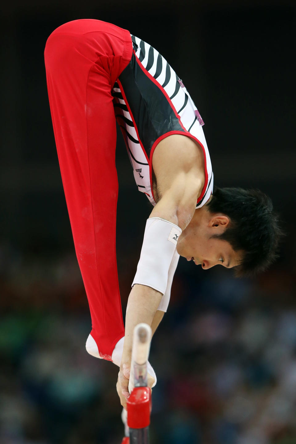 LONDON, ENGLAND - JULY 30: Kazuhito Tanaka of Japan competes on the parallel bars in the Artistic Gymnastics Men's Team final on Day 3 of the London 2012 Olympic Games at North Greenwich Arena on July 30, 2012 in London, England. (Photo by Streeter Lecka/Getty Images)