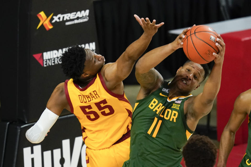 Baylor guard Mark Vital (11) fights for a rebound with Iowa State guard Darlinstone Dubar (55) during the first half of an NCAA college basketball game, Saturday, Jan. 2, 2021, in Ames, Iowa. (AP Photo/Charlie Neibergall)