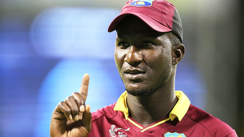 Darren Sammy points his finger to signal out.