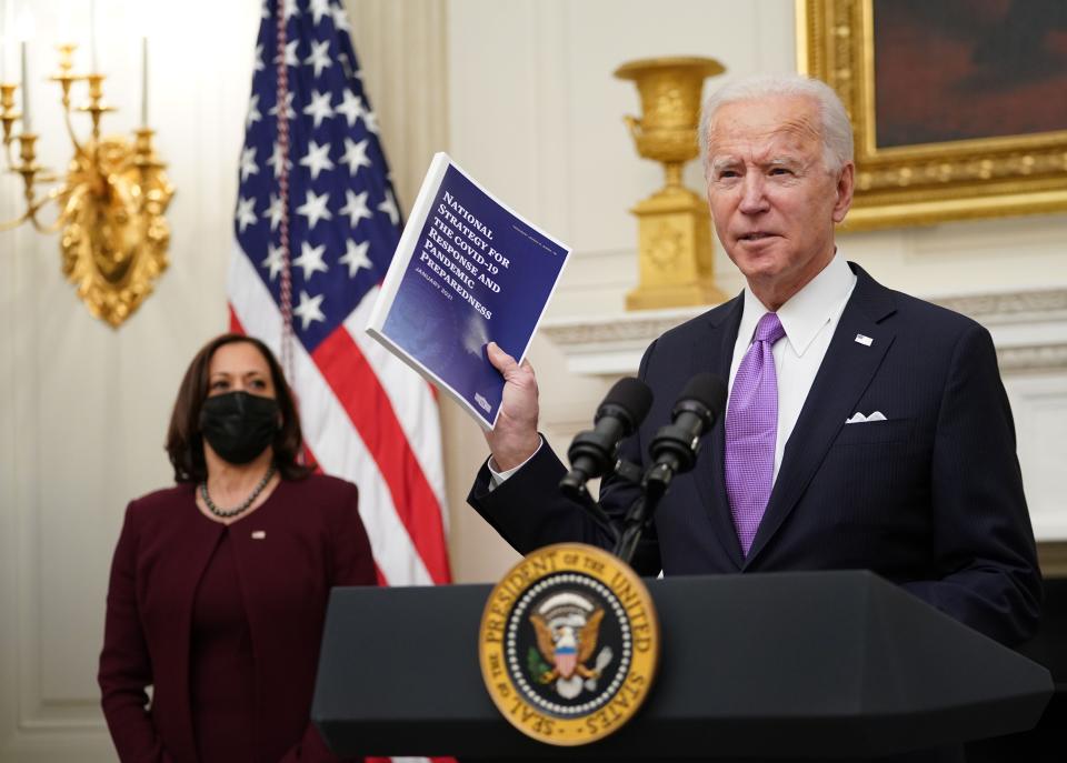 US President Joe Biden speaks about the Covid-19 response as US Vice President Kamala Harris (L) looks on before signing executive orders in the State Dining Room of the White House in Washington, DC, on January 21, 2021. (Photo by MANDEL NGAN / AFP) (Photo by MANDEL NGAN/AFP via Getty Images)