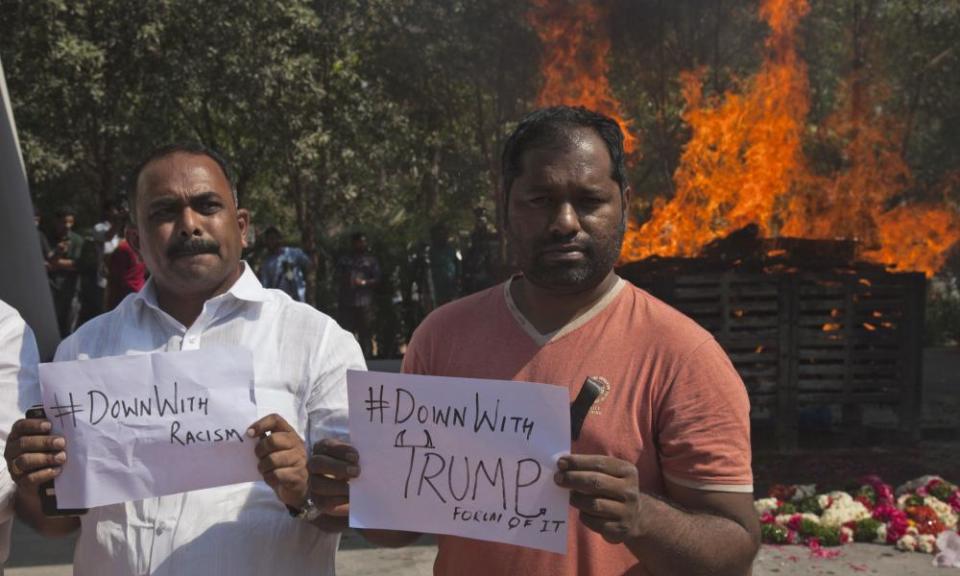 Indians hold placards in front of Srinivas Kuchibhotla’s cremation pyre