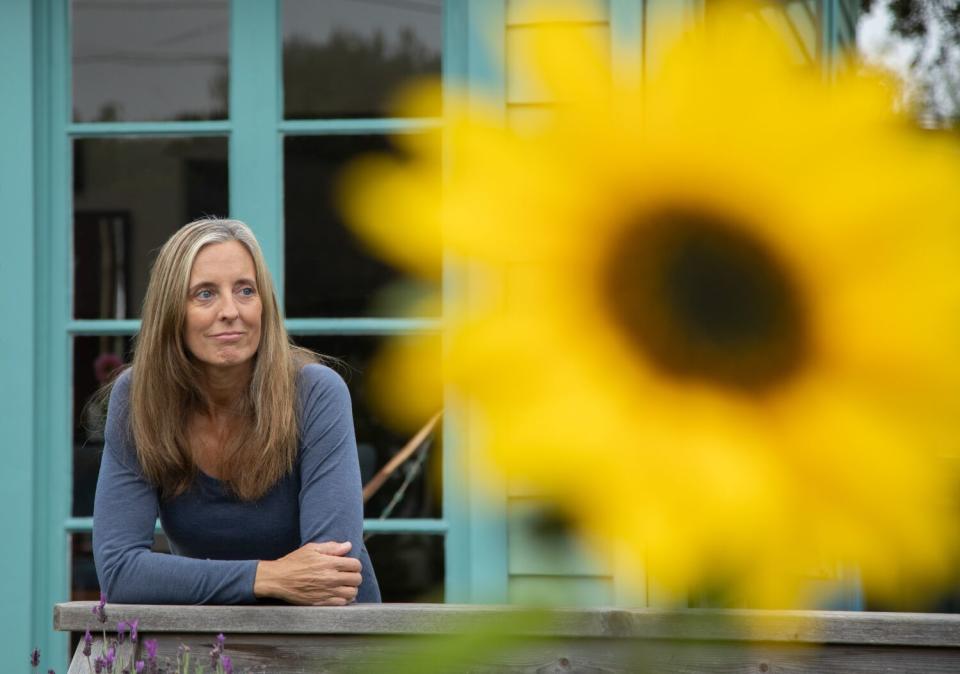 Woman at porch with giant yellow flower