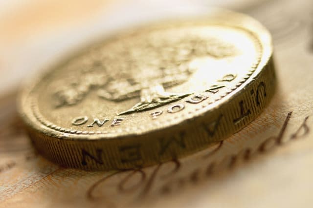 Close up of British pound coin and currency