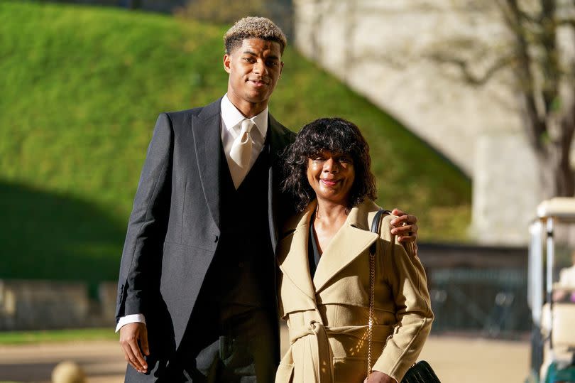 Marcus Rashford, pictured with his mother Melanie, was awarded an MBE for services to vulnerable children in the UK