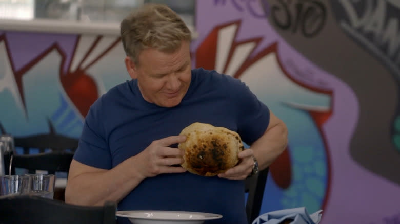 Ramsay holds a burned bread bowl to his chest