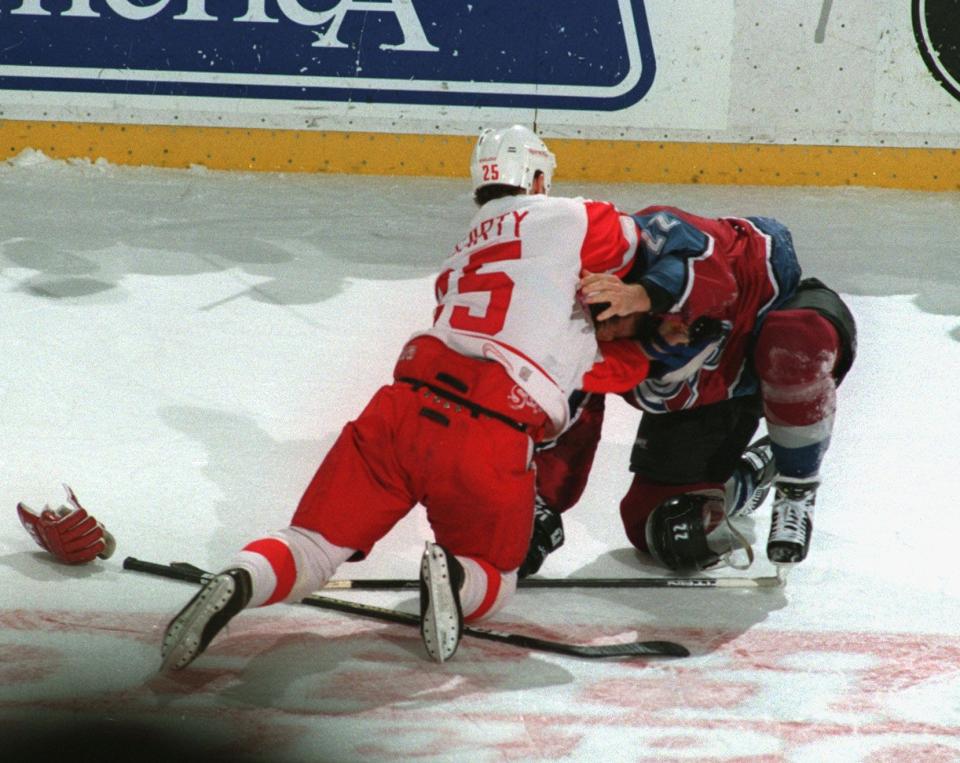Red Wings forward Darren McCarty and Avalanche forward Claude Lemieux fight during the first period on March 26, 1997, at Joe Louis Arena.