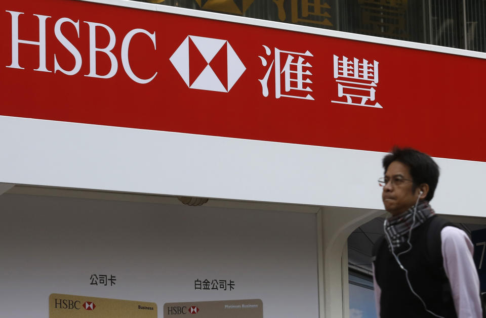 A man walks past an advertisement by HSBC in Hong Kong January 9, 2013. HSBC's sale of its $9.4 billion stake in Ping An Insurance to Thailand's CP Group has been thrown into jeopardy after state-run China Development Bank (CDB) voiced concerns over funding for the deal, sources told Reuters.REUTERS/Tyrone Siu (CHINA - Tags: BUSINESS)