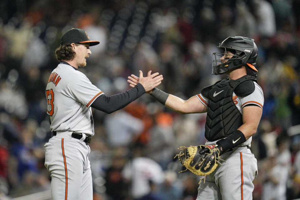 Baltimore Orioles relief pitcher Mike Baumann celebrates with catcher James McCann after the team's baseball game against the Washington Nationals at Nationals Park, Wednesday, April 19, 2023, in Washington. The Orioles won 4-0. (AP Photo/Jess Rapfogel)