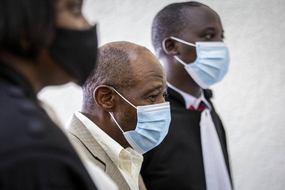 Paul Rusesabagina, center, who inspired the film "Hotel Rwanda" for saving people from genocide, appears at the Kicukiro Primary Court in the capital Kigali, Rwanda Monday, Sept. 14, 2020. Rusesabagina became famous for protecting more than 1,000 people as a hotel manager during Rwanda's 1994 genocide and was awarded the U.S. Presidential Medal of Freedom in 2005 but Rwandan authorities accused him of supporting the armed wing of his opposition political platform, which has claimed responsibility for deadly attacks inside Rwanda. (AP Photo)