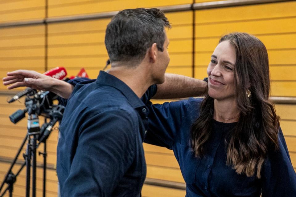 Jacinda Ardern hugs her fiancee Clark Gayford after announcing her resignation (AP)