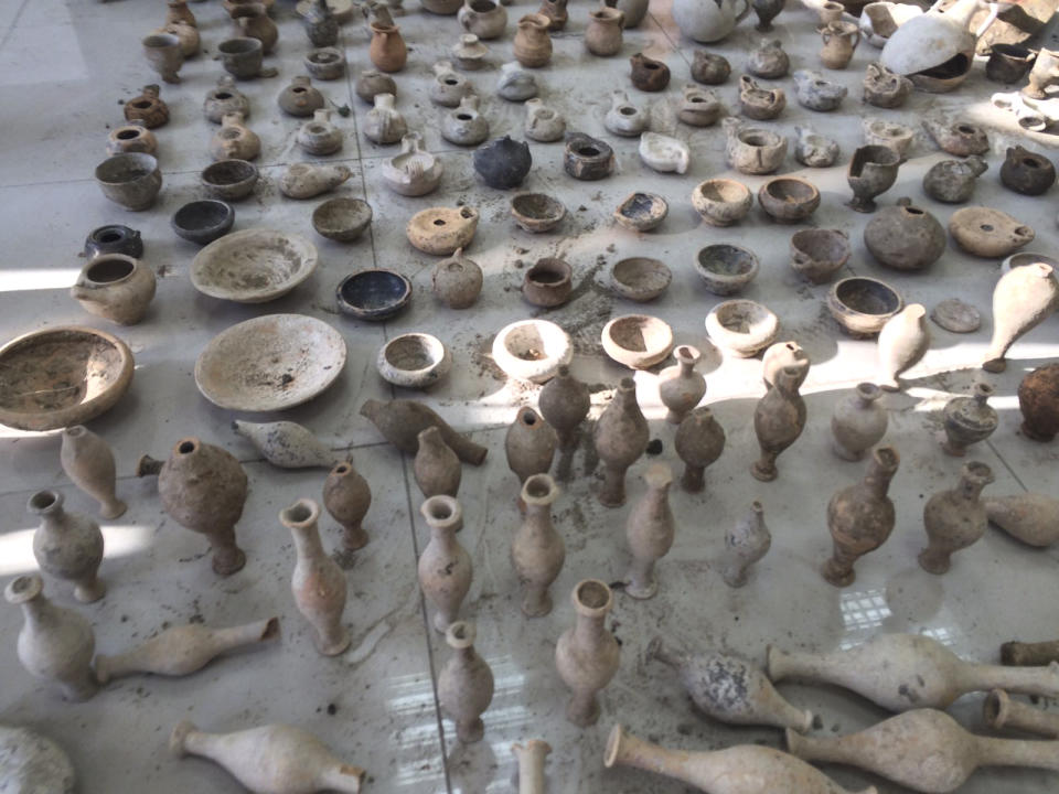 In this undated photo provided by the Albanian Police on Sunday, Feb. 12, 2017, Archaeological artifacts from ancient Apollonia on display, in Radostine, Albania. Albanian police say they have prevented the smuggling of 230 archaeological artifacts from ancient Apollonia and have arrested two people adding that the artifacts were found at the arrested men's houses in Radostine, a village 120 kilometers (75 miles) south of the capital, Tirana. (Albania Police via AP)