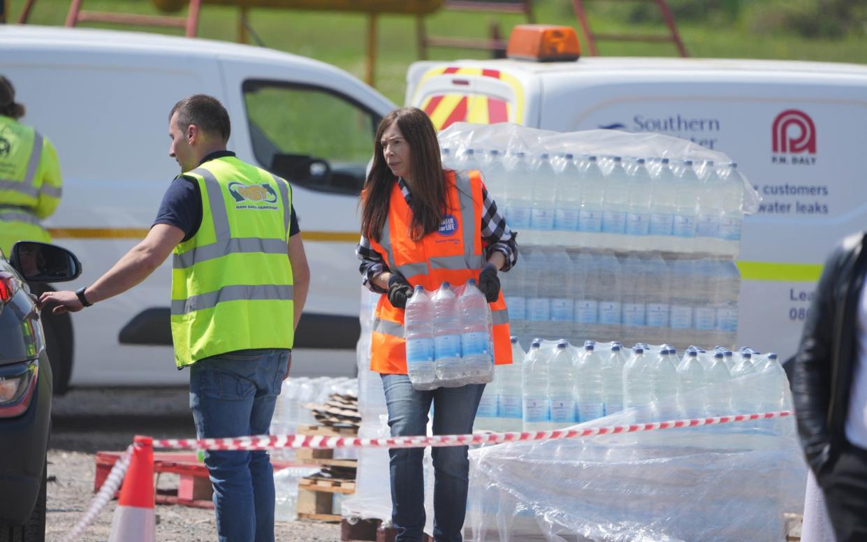 People handing out bottles of water - Eddie Mitchell