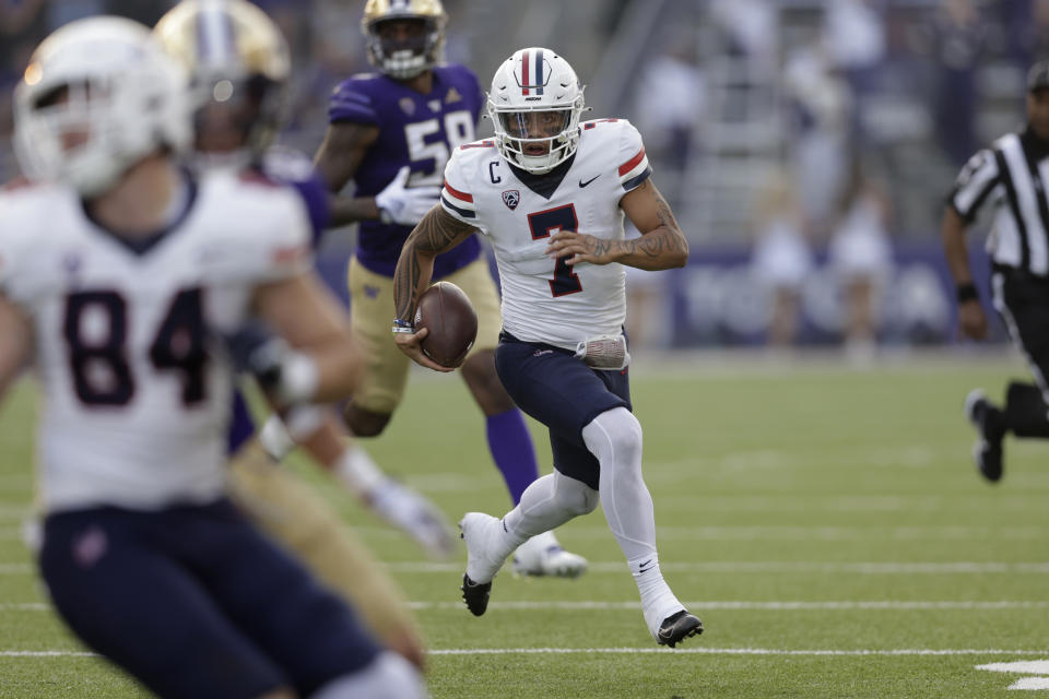 Arizona quarterback Jayden de Laura scrambles with the ball against Washington during the second half of an NCAA football game, Saturday, Oct. 15, 2022, in Seattle. Washington won 49-39. (AP Photo/John Froschauer)