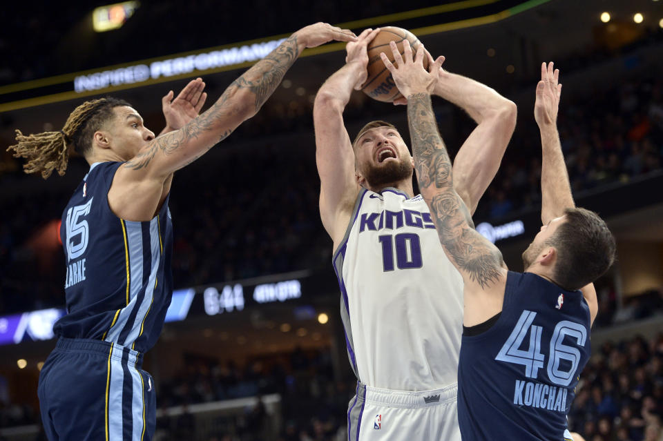 Sacramento Kings forward Domantas Sabonis (10) shoots against Memphis Grizzlies forward Brandon Clarke and guard John Konchar (46) in the second half of an NBA basketball game, Tuesday, Nov. 22, 2022, in Memphis, Tenn. (AP Photo/Brandon Dill)