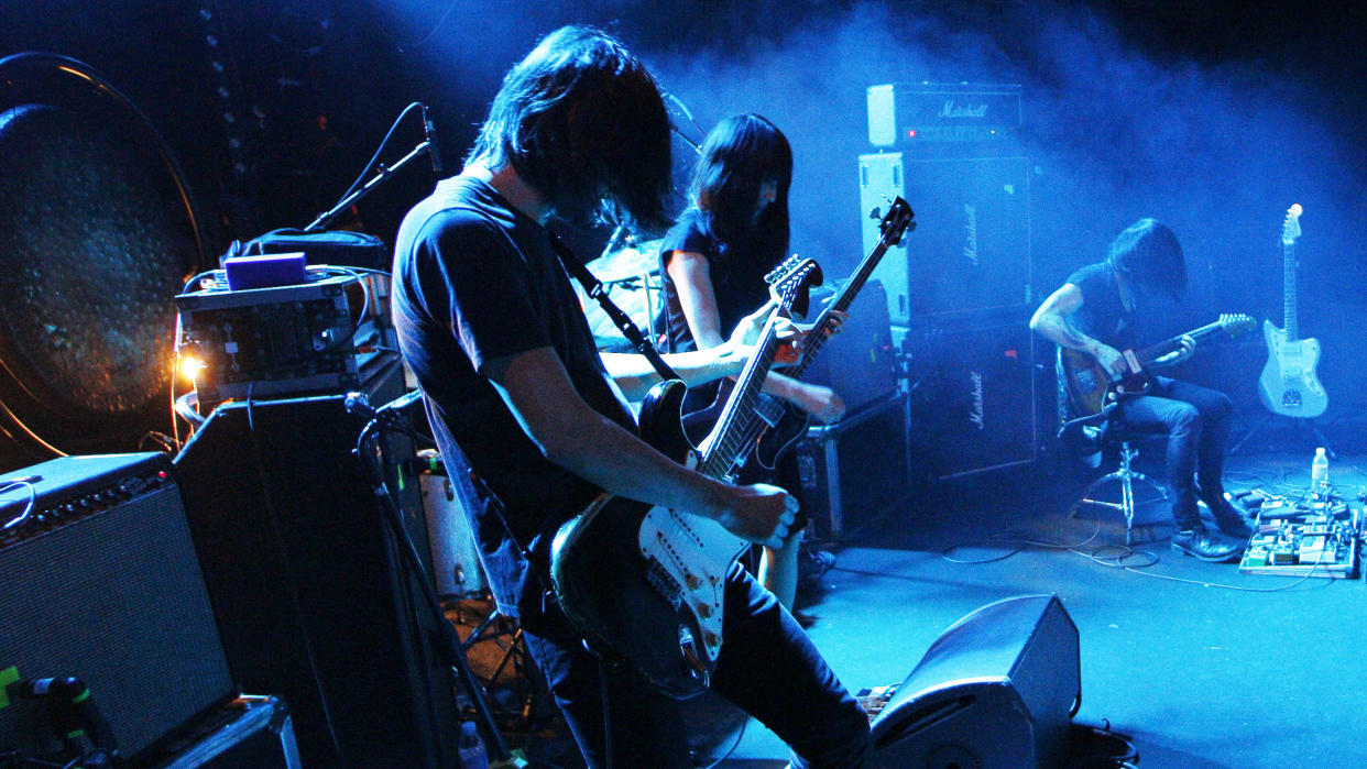  The members of the Japanese experimental rock band Mono perform on stage at the Trabendo in Paris on December 11, 2014. 