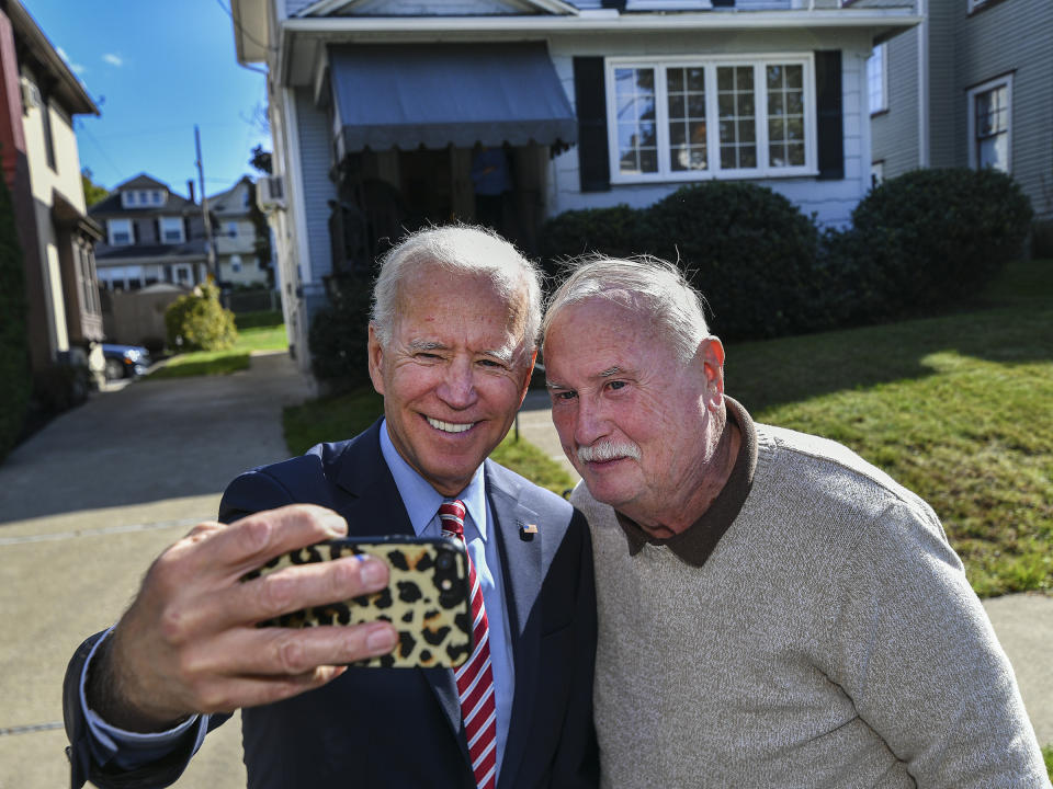 Former U.S. Vice President Joe Biden takes a selfie with Paul McGloin while visiting his childhood home in Scranton Pa., on Wednesday, Oct. 23, 2019. (Jason Farmer/The Times-Tribune via AP)