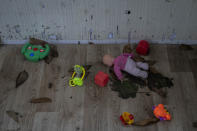 Toys and a doll lay on the floor of a playhouse in the courtyard of Kherson regional children's home in Kherson, southern Ukraine, Friday, Nov. 25, 2022. Throughout the war in Ukraine, Russian authorities have been accused of deporting Ukrainian children to Russia or Russian-held territories to raise them as their own. At least 1,000 children were seized from schools and orphanages in the Kherson region during Russia’s eight-month occupation of the area, their whereabouts still unknown. (AP Photo/Bernat Armangue)