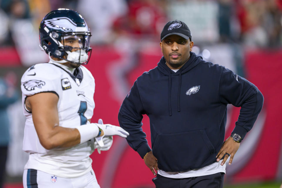 Former Philadelphia Eagles offensive coordinator Brian Johnson watches quarterback Jalen Hurts (1) before a wild-card playoff game against the Buccaneers. (AP Photo/Doug Murray)