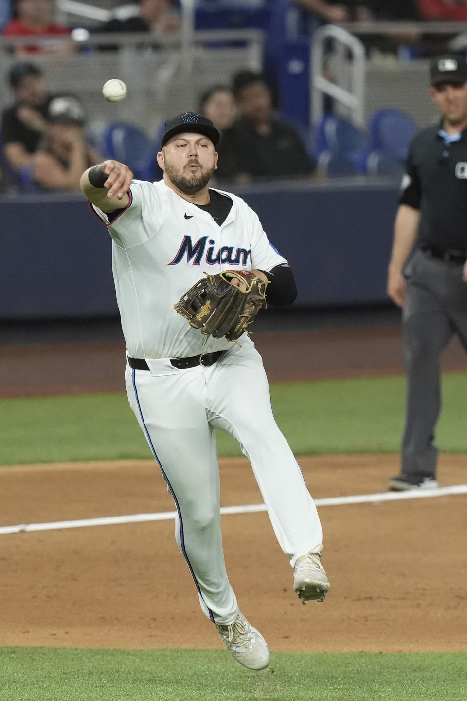 Miami Marlins third baseman Jake Burger (36) throws to first base on a ground ball by Los Angeles Angels' Aaron Hicks during the eighth inning of a baseball game, Monday, April 1, 2024, in Miami. (AP Photo/Marta Lavandier)