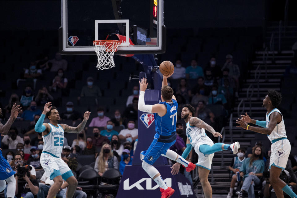 Dallas Mavericks guard Luka Doncic (77) shoots during the first half of the team's NBA preseason basketball game against the Charlotte Hornets, Wednesday, Oct. 13, 2021, in Charlotte, N.C. (AP Photo/Matt Kelley)
