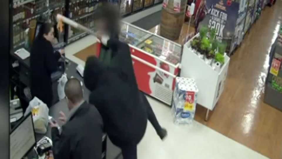 In front of terrified customers, the thief jumps over the counter. Source: 7 News