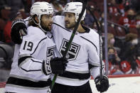 Los Angeles Kings left wing Alex Iafallo (19) is congratulated after scoring a goal by Phillip Danault (24) during the first period of an NHL hockey game against the New Jersey Devils, Sunday, Jan. 23, 2022, in Newark, N.J. (AP Photo/Adam Hunger)