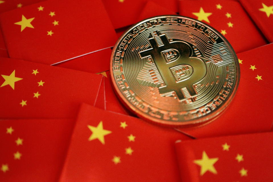 A representation of Bitcoin cryptocurrency is seen amid China's flags in this illustration picture taken September 27, 2021. REUTERS/Florence Lo/Illustration